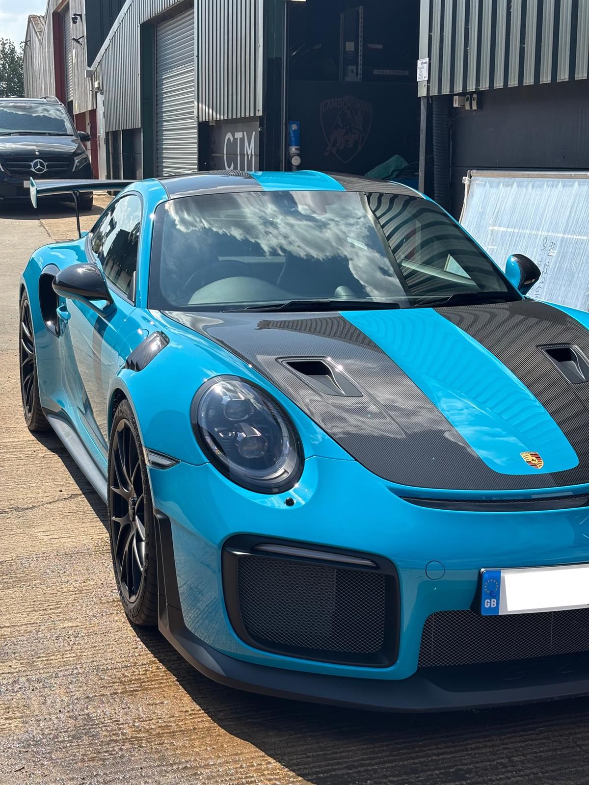Miami blue Porsche 911 GT2 RS with a deep, glass-like coated finish