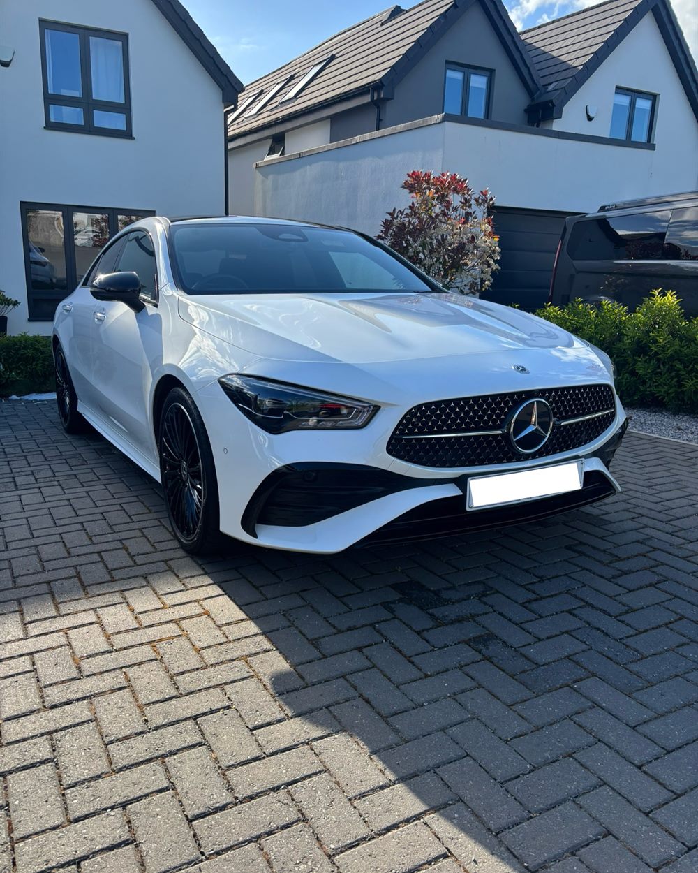 White Mercedes CLA cleaned and dried on a customer's driveway